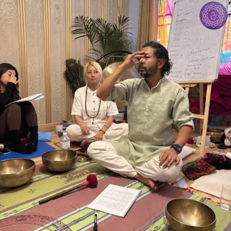 Master Amit teaching with singing bowls